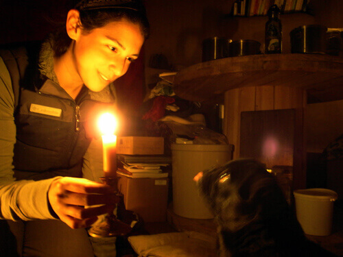 woman holding candle, having gone electricity free