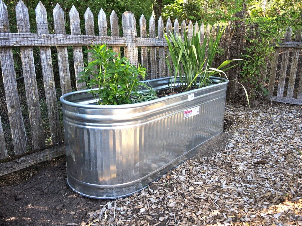 a behlen water tank used as a planter