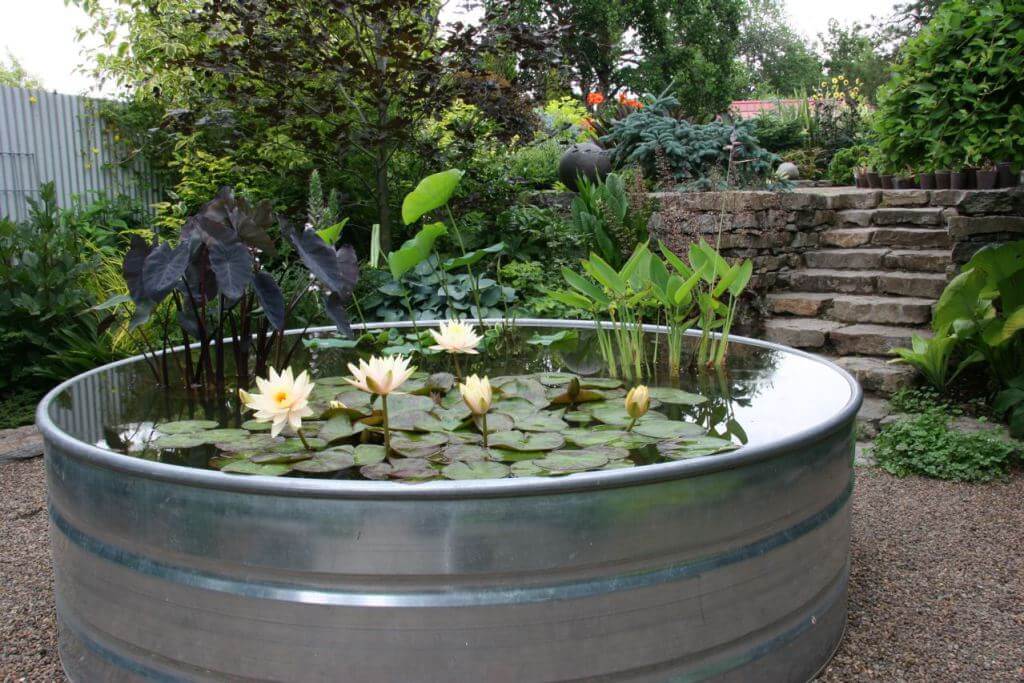 a metal planter that's a water garden