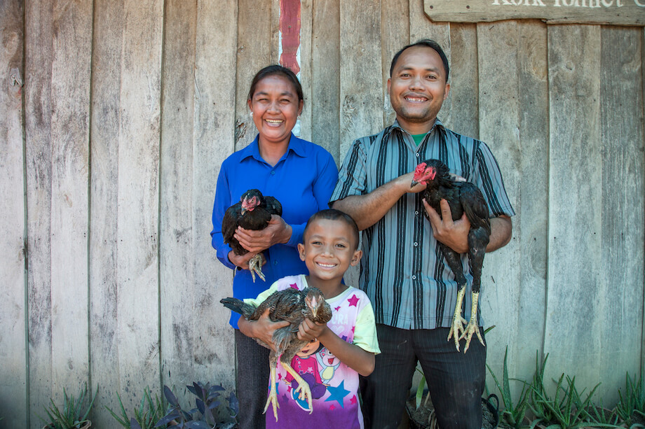 Heifer International -Cambodia, December 2015. Income II Project. Klang Savuth (43) (left), Kid Moa (43) and their son Ky Damkoeung (6) pose for a photo outside their home on December 08, 2015 in Kok Romeat Village, Cambodia.