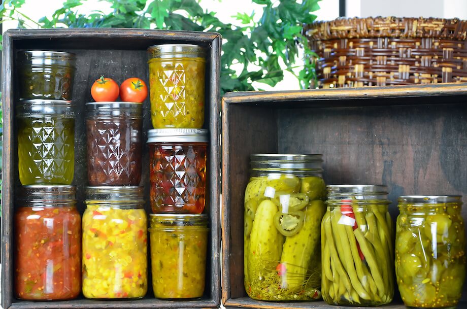 Jars of home canned vegetables in wooden boxes