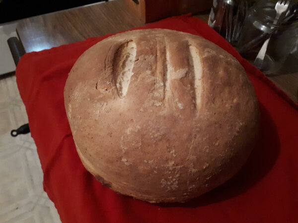 whole sourdough bread sitting on red towel