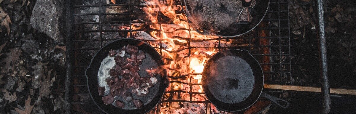camping on a dutch oven over fire